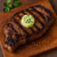 Kiawe-Smoked Grilled Ribeye with Garlic Herb Butter